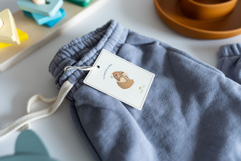 Blue drawstring bag with a tag on a light surface