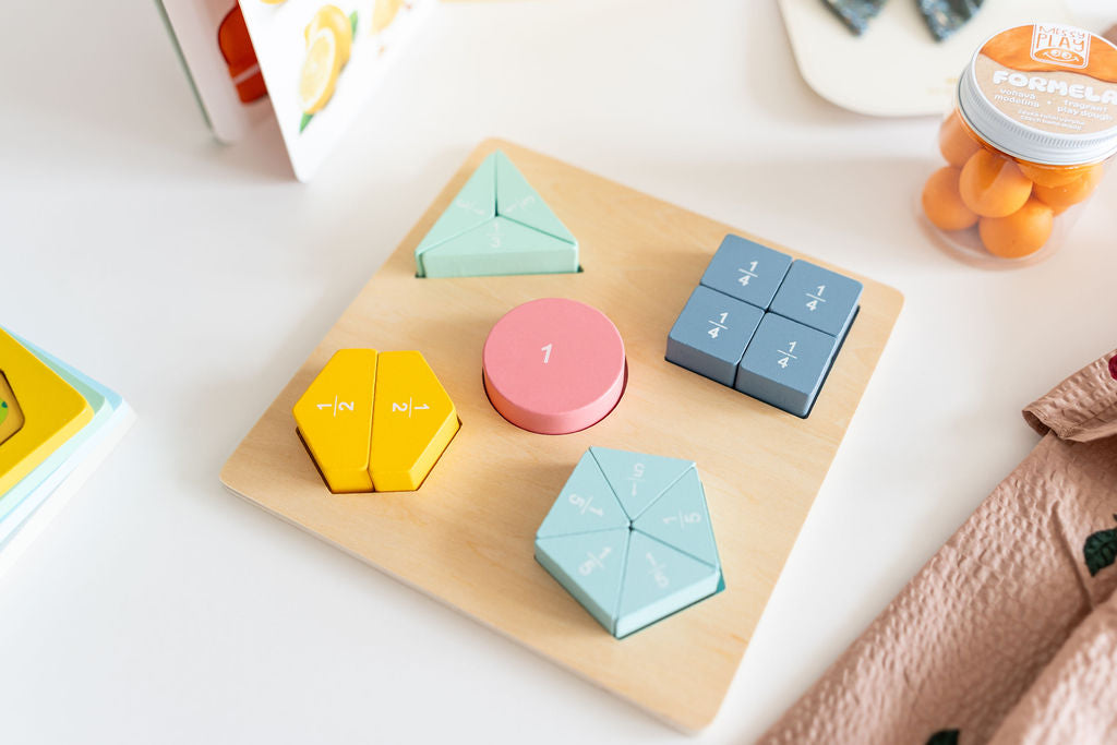 Colorful geometric-shaped calculators on a wooden board with a white background